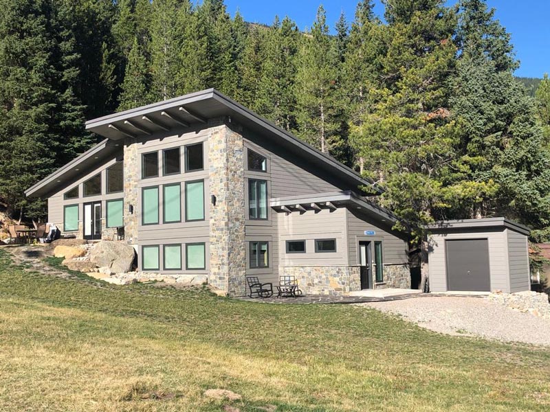 new beautiful custom home in southern alberta next to a forest